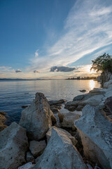 Sunset with rocks, Rock on sea with colorful sunset clouds beautiful background for travel agencies