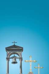 Cover page with ancient monastery poor bell tower with rich golden crosses at blue sky gradient...