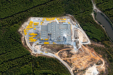 Aerial view, top view of concrete fabric into the nature forest green and industry