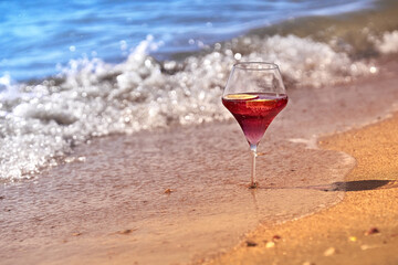 Wine glass with a cocktail by the sea.
