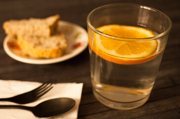 slice of orange in glass of water on the table