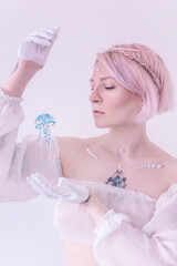 Fairy with pink hair and a jellyfish in her hands