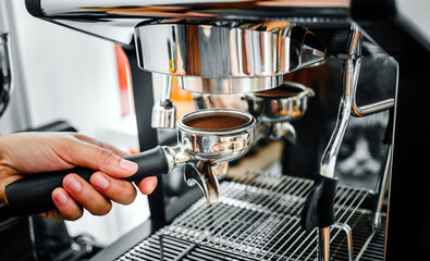 Close-up of hand barista making fresh coffee process of preparing coffee tablet before installing it into the coffee machine
