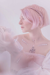 Gentle portrait of a girl with pink hair
