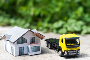 toy trucks with a house on a natural background