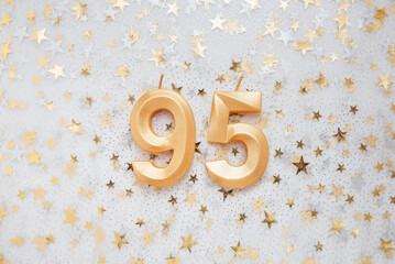 Number 95 ninety five golden celebration birthday candle on Festive Background. ninety five years birthday. concept of celebrating birthday, anniversary, important date, holiday