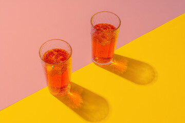 Refreshing pink punch cocktail on color background