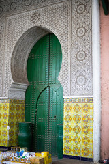 Arabian architecture facade style on a green door mosque gate in Marrakesh, Morocco