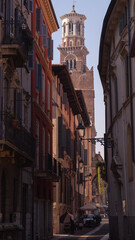 Fototapeta premium View of church spire in street with balconies
