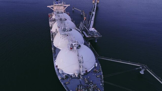Aerial of Liquified Natural Gas LNG carrier moored to a small gas terminal. Fuel crisis. Sanctions