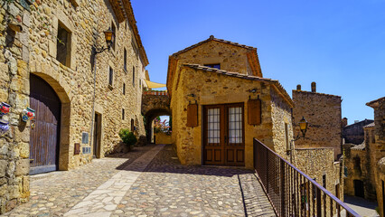 Fototapeta na wymiar Houses built with stone in the picturesque medieval village of Pals, Girona, Catalonia.