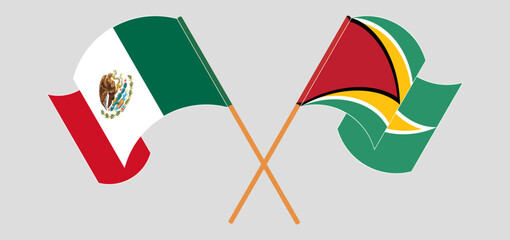 Crossed and waving flags of Mexico and Guyana