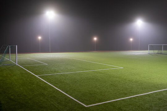 Image of soccer field in night with spotlight