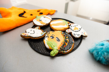 Step by step instructions on how to draw an orange pumpkin shaped gingerbread cookie using icing. DIY Master class from pastry chef in six steps. Halloween sweets on an isolated background.Copy space.