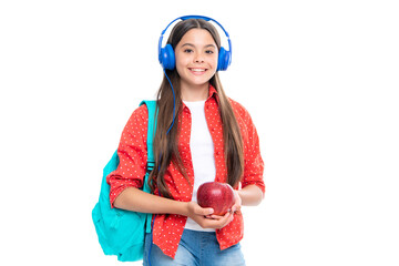 Schoolgirl, teenage student lifestyle girl in headphones hold books on white isolated studio background. School and music education concept. Portrait of happy smiling teenage child girl.