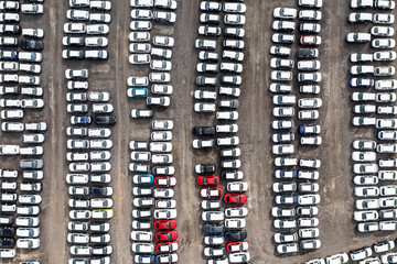 Fototapeta na wymiar Aerial view directly above rows of new and imported cars