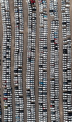Aerial view directly above rows of new cars at a vehicle manufacturer 