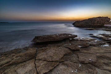 Cracks on flat rocks in the beach sunset nachsholim Israel