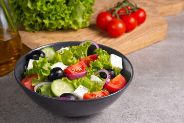 Fresh Greek salad with delicious rucola, spinach, arugula, feta cheese, cucumber, red onion and cherry tomato Healthy and diet food concept.