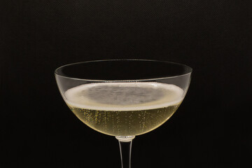 Sparkling wine Martini Asti in a glass on a black background