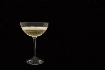 Sparkling wine Martini Asti in a glass on a black background
