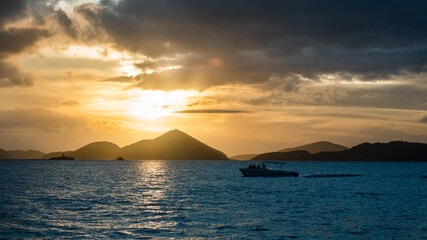 Boat motoring by during sunset looking at St. Thomas USVI - 528498245