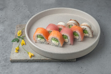 set of maki sushi with salmon, tuna, eel on gray background