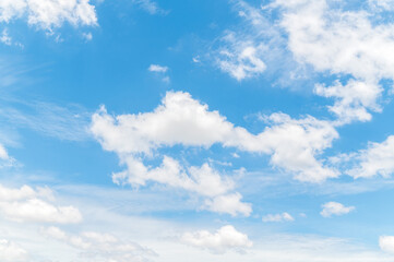 Naklejka na ściany i meble Beautiful white fluffy clouds in blue sky. Nature background from white clouds in sunny day