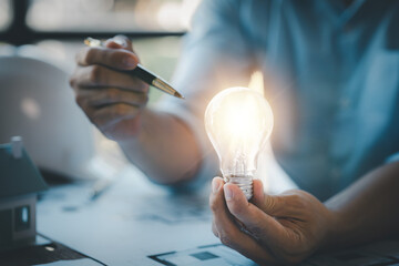 Architects holding light bulbs, Creative new idea. Innovation, finding ideas to design creative and...