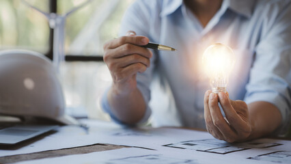 Architects holding light bulbs, Creative new idea. Innovation, finding ideas to design creative and...