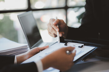 Atmosphere of a startup company meeting, business people are meeting together to summarize and plan investment finances, they are the founders of the company. Business administration concept.