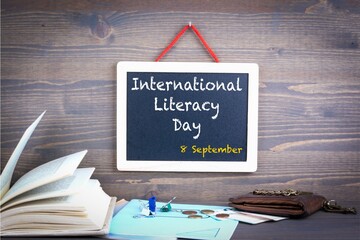 international literacy day read and write concept, random letters around black background