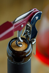 Red wine bottle opening, selective focus, macro photography