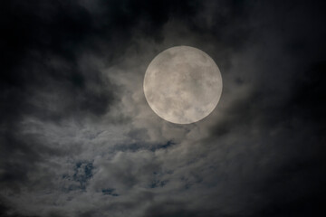 Fototapeta na wymiar Full moon in an overcast night