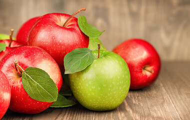 Red and green apples on a wooden table