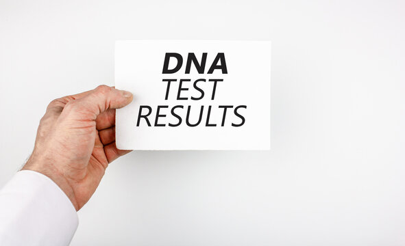 Doctor, the patient is holding a sheet with the words DNA TEST RESULTS. The concept of paternity test results, dna test.
