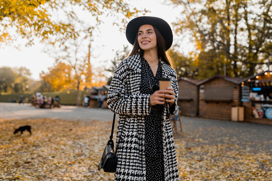 attractive young woman walking in autumn wearing coat