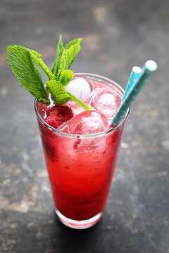 Red Cocktail, Rasberry Mojito, Long Drink With Ice Cubes And Rasberries, On A Black Stone Background, Selective Focus.