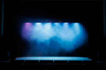 Theatrical scene without actors, scenic colorful light and smoke