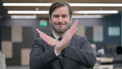 Portrait of Businessman Showing No Sign Arms Crossed
