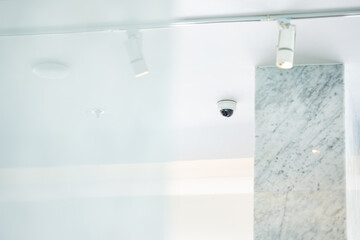 CCTV with the dome is hung on a white ceiling for circuit television guard protection.. © Surachetsh