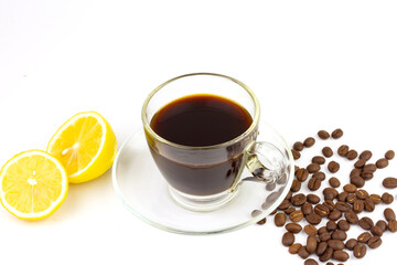 Black coffee in transparent glass with fresh lemon and coffee bean isolated on white background. Espresso romano drink for healthy.