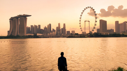 Fototapeta premium People exercising together in a city park at early evening, Singapore.