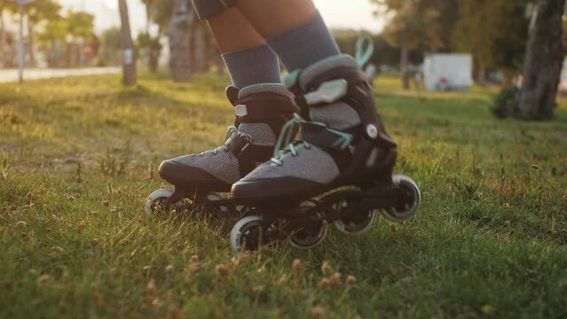 Close up of skating roller exercises for beginners on grass.