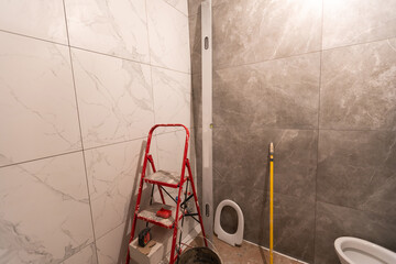 bathroom renovation and tiling. Laying floor ceramic tile