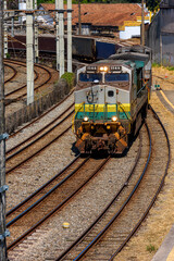 Freight train worn out by time and use arriving in the city of Belo Horizonte, Minas Gerais
