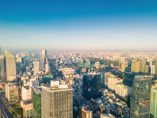Fototapeta premium Aerial panoramic cityscape view of Ho Chi Minh city and Saigon river, Vietnam. Center of heart business at downtown with buildings and towers.
