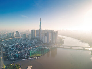 Fototapeta na wymiar Aerial view of Ho Chi Minh City skyline and skyscrapers on Saigon river, center of heart business at downtown. Morning view. Far away is Landmark 81 skyscraper