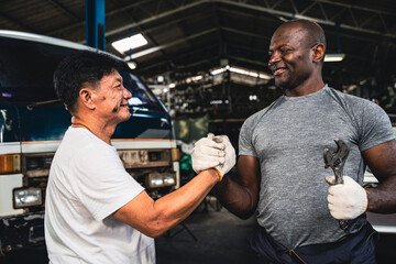 Male mechanic checking hands In the other hand in the garage.