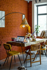 Cozy workspace with laptop on beautiful wooden table in living room